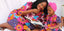 Elisamama - mommy reading book to daughter while wearing African print dresses
